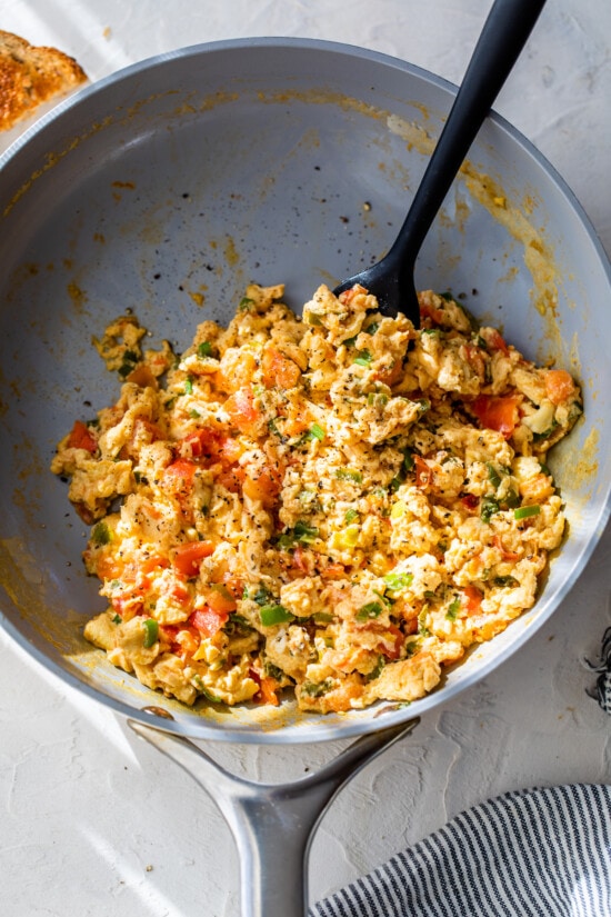 Huevos Pericos in skillet with spatula