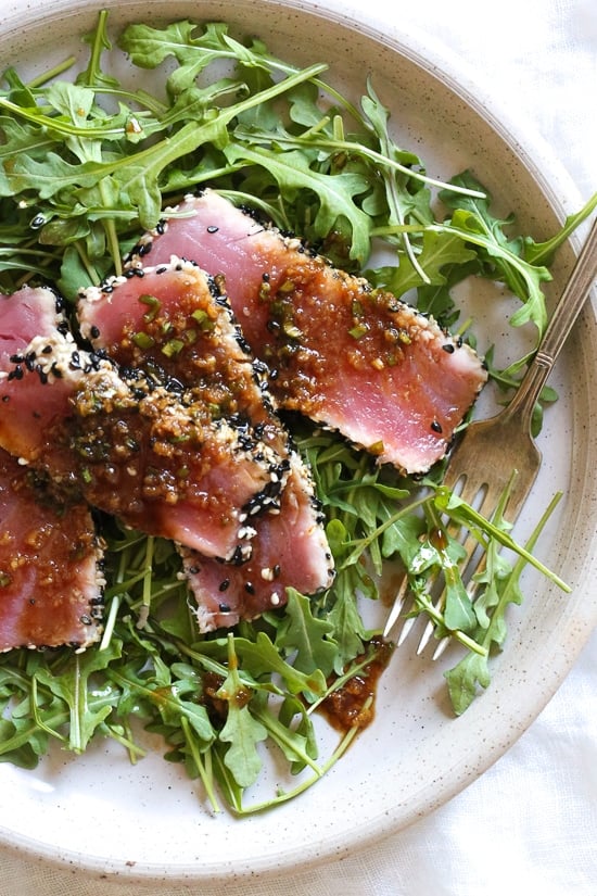 Sesame Crusted Tuna Steak on Arugula drizzled with a balsamic soy-ginger vinaigrette – yum!