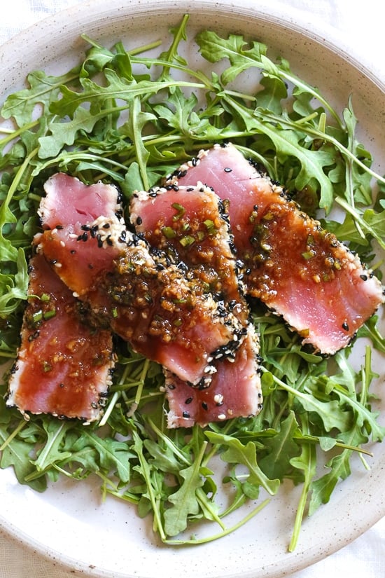 Sesame Crusted Tuna Steak on Arugula drizzled with a balsamic soy-ginger vinaigrette – yum!