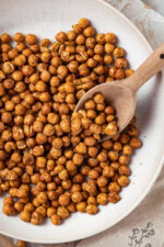 Scooping roasted chickpeas from bowl