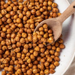 Scooping roasted chickpeas from bowl