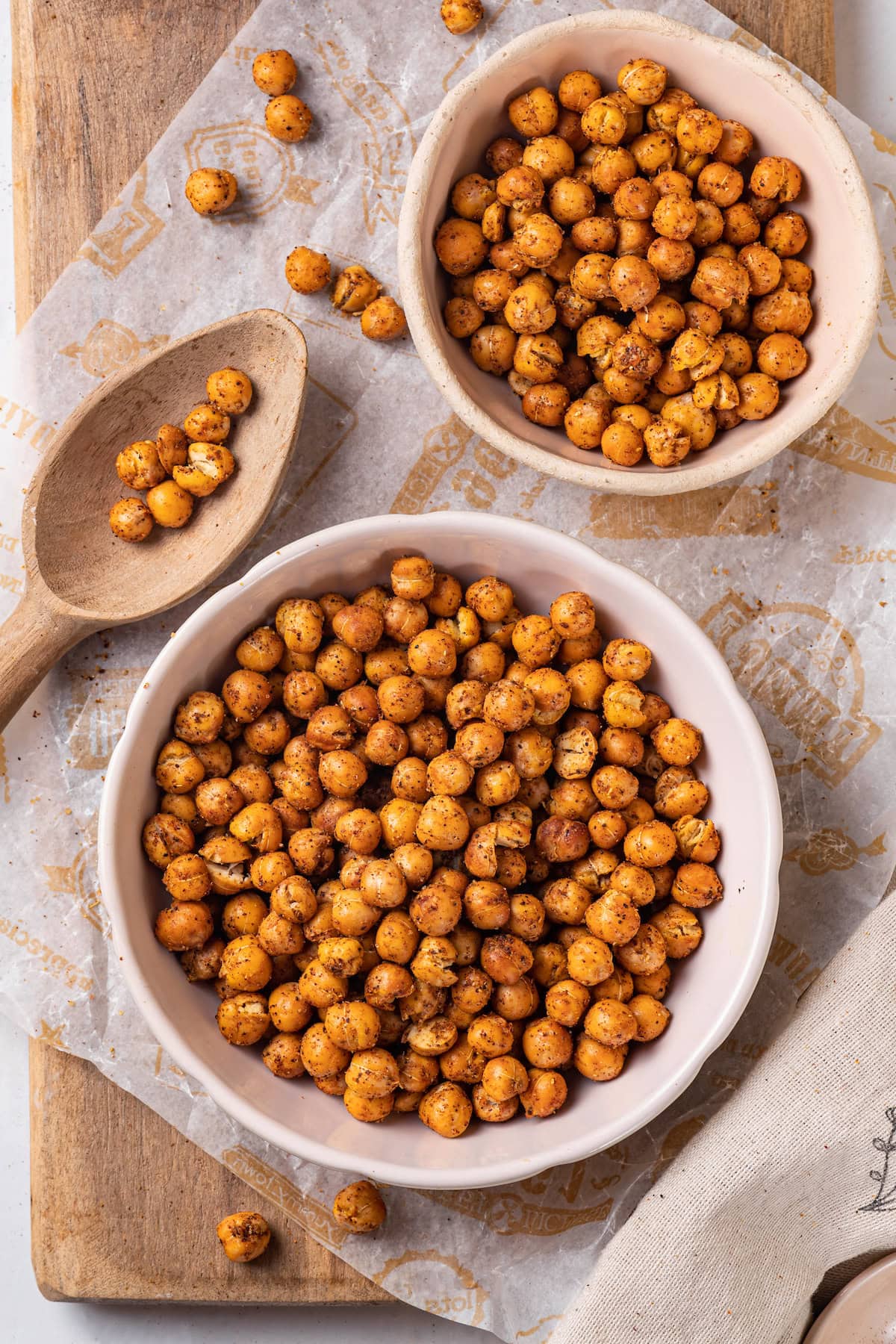 This crispy roasted chickpeas recipe is perfectly spiced, with lots of crunch! It's an easy snack that's packed with protein and fiber. Overhead view of roasted chickpeas in bowls