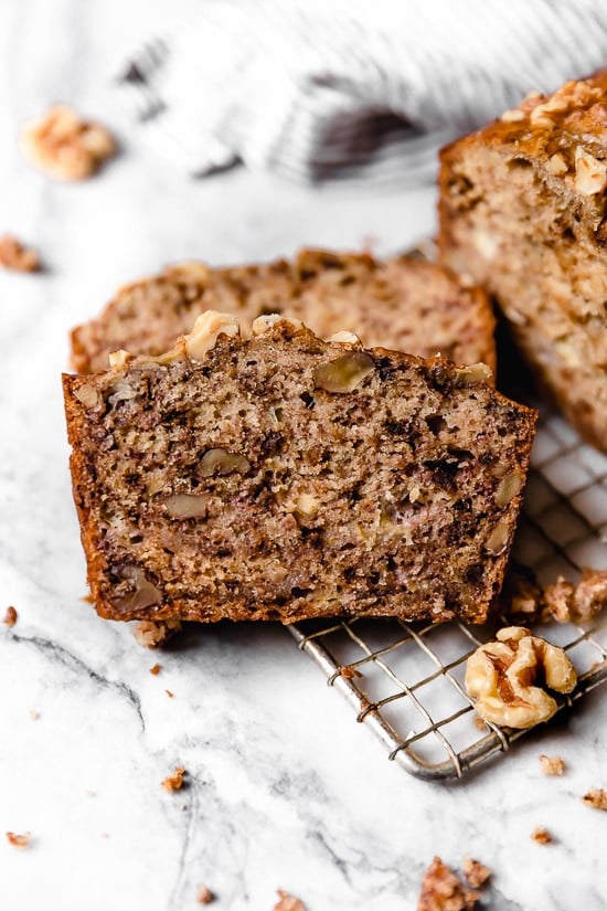 This super moist, banana nut bread recipe is insanely delicious and healthier than most because it uses less butter, oil and sugar than most recipes. banana nut bread slices with walnuts