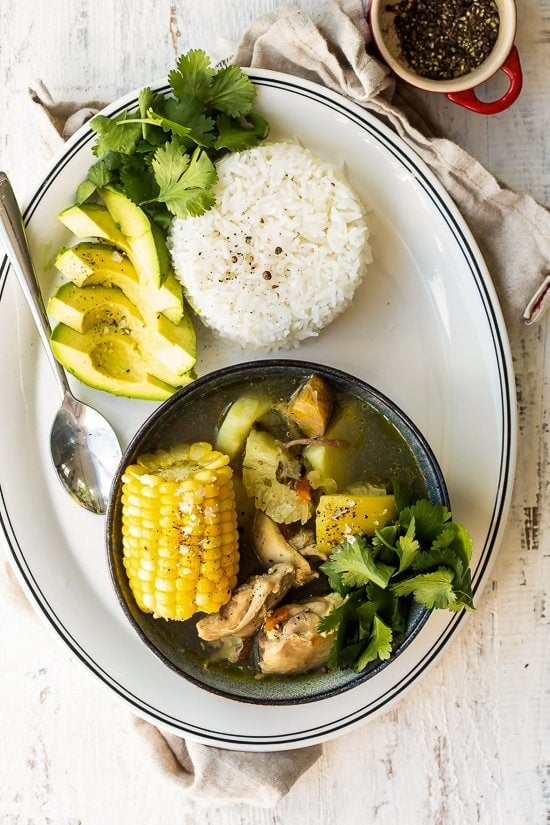 Bowl of Sancocho with rice and avocado