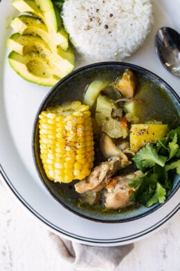 Bowl of Sancocho with rice and avocado