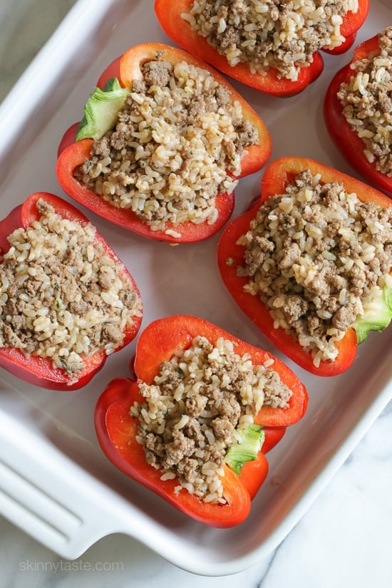 Halved stuffed peppers on a tray.