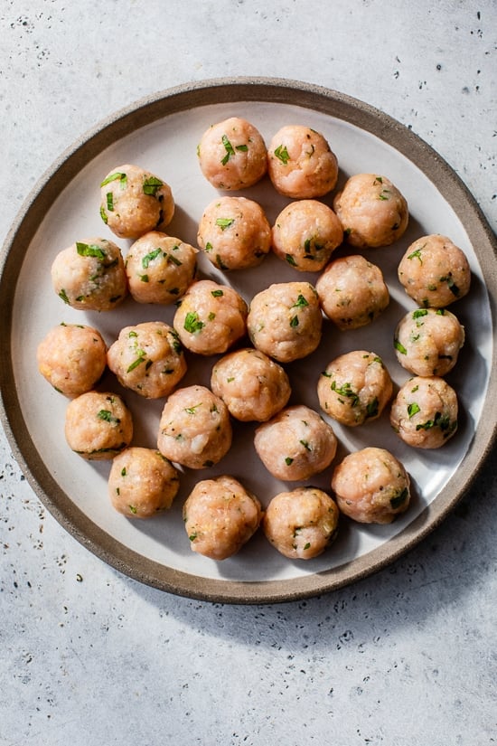 Ground turkey meatballs rolled up on a plate.