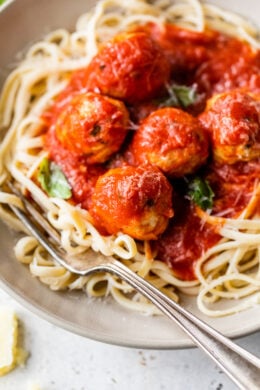 Italian Turkey Meatballs with spaghetti on a plate.