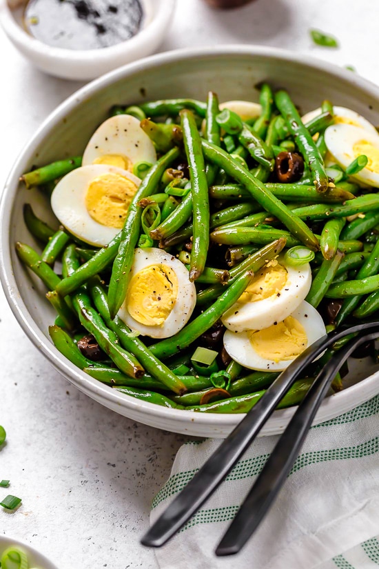 One of my favorite ways to enjoy green beans–in a chilled green bean salad recipe! The delicious flavors of these balsamic green beans made with black olives, scallions and eggs complement any meal or holiday potluck.