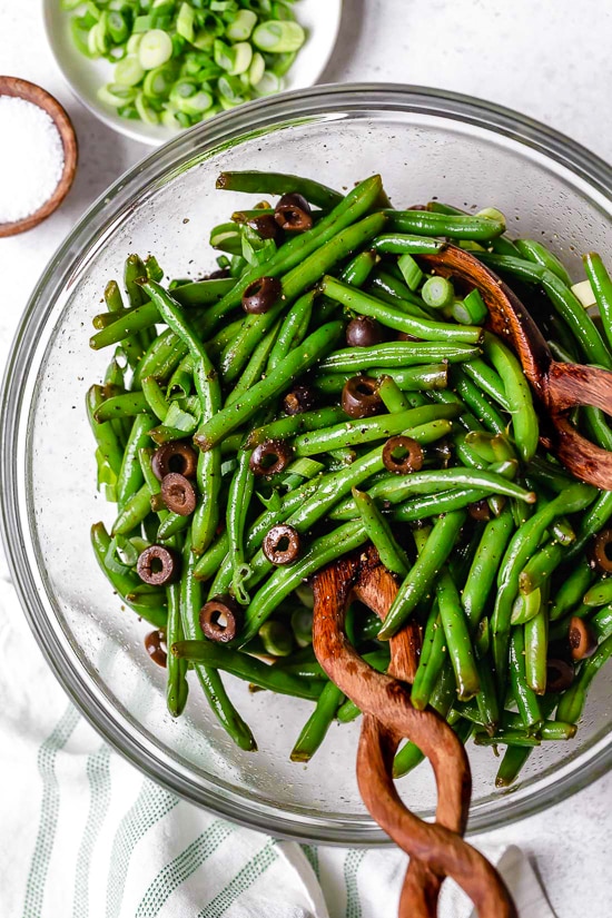 One of my favorite ways to enjoy green beans–in a chilled green bean salad recipe! The delicious flavors of these balsamic green beans made with black olives, scallions and eggs complement any meal or holiday potluck.