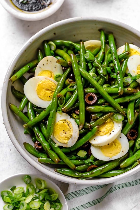 One of my favorite ways to enjoy green beans–in a chilled green bean salad recipe! The delicious flavors of these balsamic green beans made with black olives, scallions and eggs complement any meal or holiday potluck.