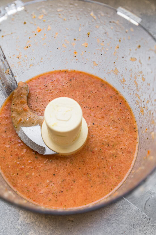 Layers of hard boiled eggs, bacon, blue cheese, tomatoes and avocado make up this classic Cobb salad recipe. It's the perfect lunch salad! Tomato red wine vinaigrette in food processor bowl
