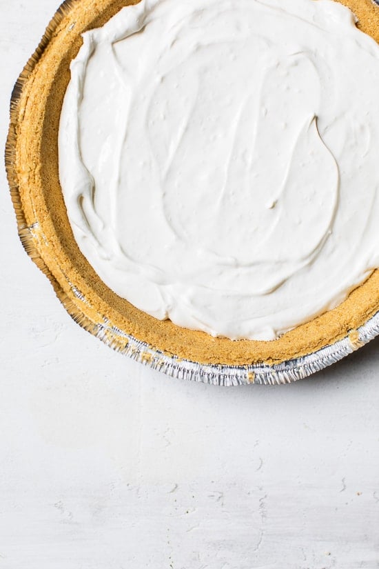 Overhead view of no-bake cheesecake filling added to crust