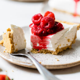No-bake cheesecake slice on plate with tip of cake on fork