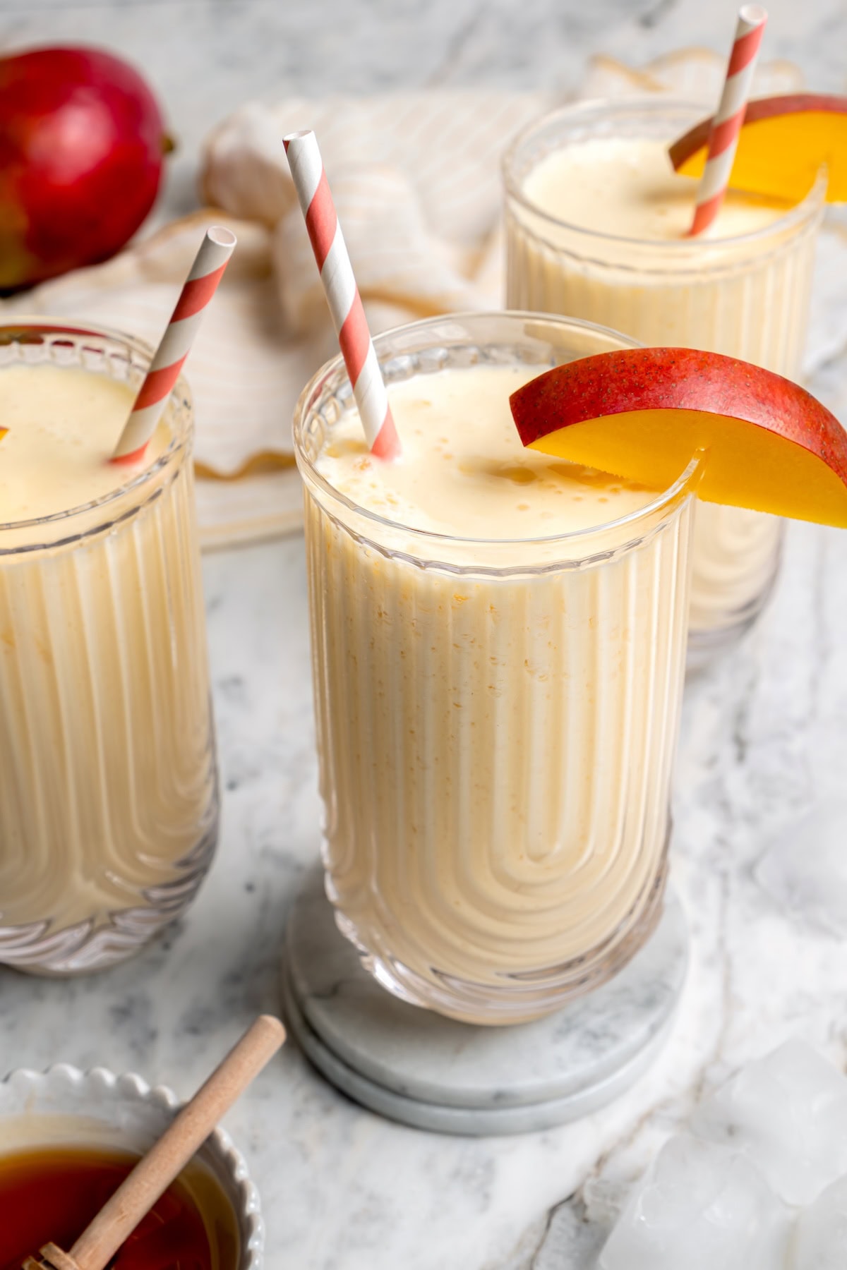 3 glasses filled with homemade mango lassi