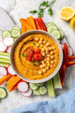 Overhead view of roasted red pepper hummus with fresh veggies