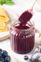 Jar of blueberry compote with spoon