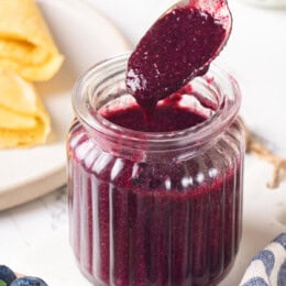 Jar of blueberry compote with spoon