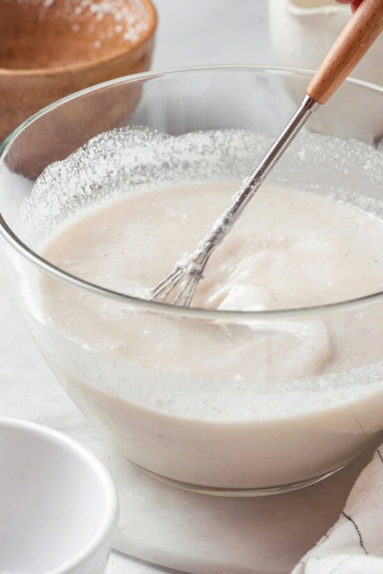 These homemade coconut popsicles are rich, creamy, and super simple to make! They’re the perfect summertime refresher. Homemade coconut cream pop mixture in bowl