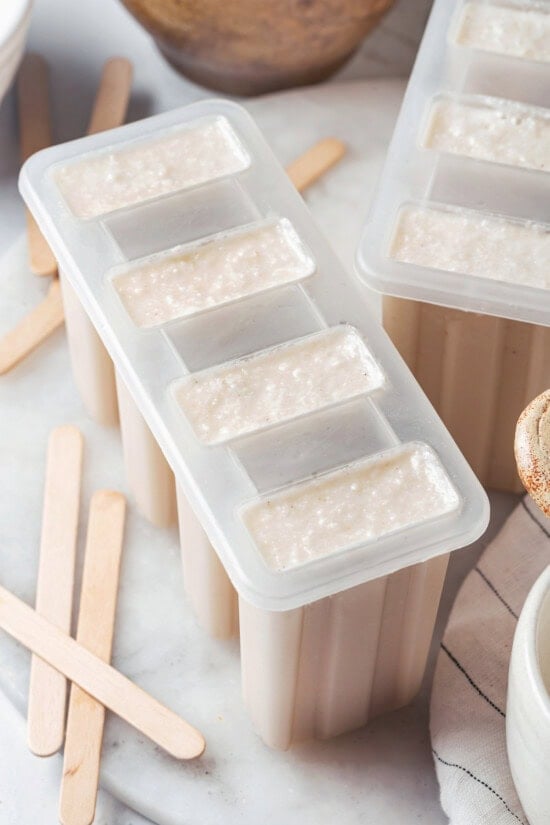 These homemade coconut popsicles are rich, creamy, and super simple to make! They’re the perfect summertime refresher. Coconut pop mixture in popsicle mold