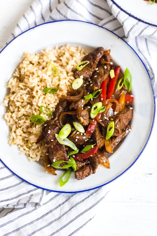 Pepper steak is quick, easy and perfect to whip up any night of the week. Strips of beef and bell peppers are stir fried in a wok to create a delicious main dish, ready in no time! I love it with brown rice, but cauliflower rice would also be great on the side.