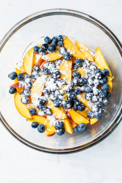 peaches and blueberries in a bowl