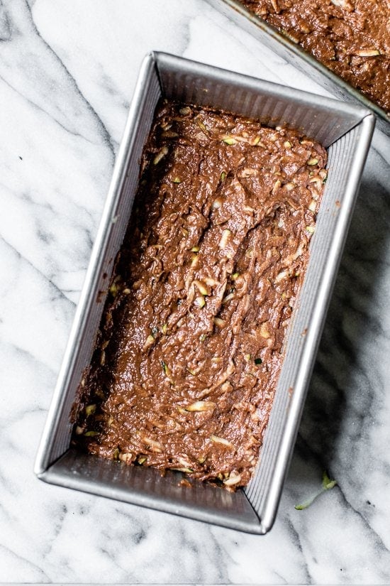 This Chocolate Zucchini Bread is so rich and delicious, no one will guess that it's secretly healthy! Add walnuts for crunch in every bite. Chocolate Zucchini Bread in a metal pan