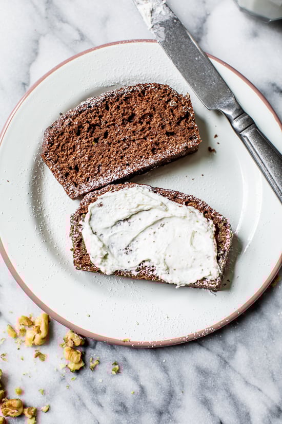 This Chocolate Zucchini Bread is so rich and delicious, no one will guess that it's secretly healthy! Add walnuts for crunch in every bite. Chocolate Zucchini Bread slices on a plate