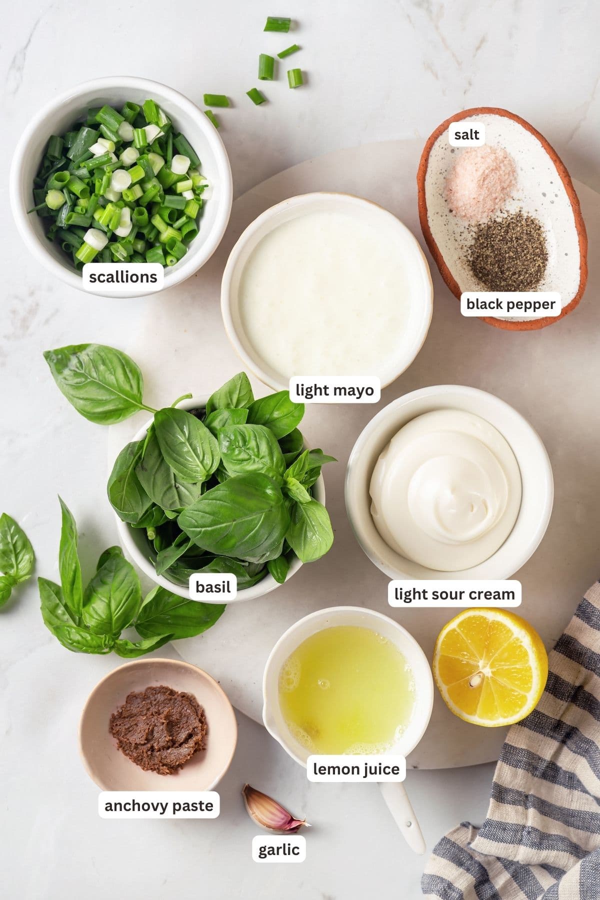 Basil green goddess dressing is the perfect way to give your next salad an upgrade! This version is lightened up, but still rich and creamy. Overhead view of ingredients for basil green goddess dressing with labels