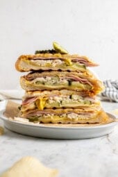 Stack of 4 leftover turkey Cuban sandwiches on plate