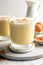Two glasses of homemade eggnog with grated nutmeg