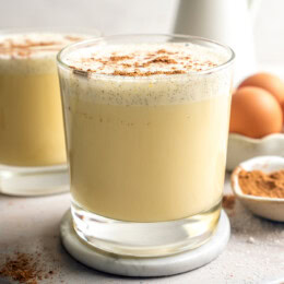Two glasses of homemade eggnog with grated nutmeg