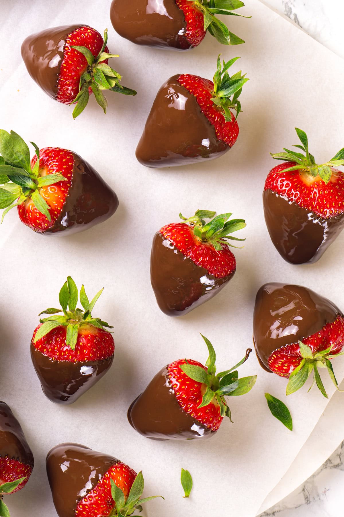 Chocolate-covered strawberries are an elegant treat that's incredibly easy to make at home. You'll never buy them at the store again! Freshly dipped chocolate strawberries on wax paper