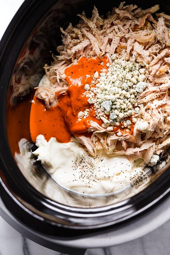 This Slow Cooker Buffalo Chicken Dip has everything you love about buffalo wings, only made into a dip – no messy hands!