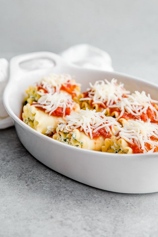 These EASY Spinach Lasagna Roll ups are totally delicious, perfect for entertaining or serving for weeknight meals. Individual vegetarian lasagnas filled with spinach and cheese are family-friendly, satisfying and perfect for portion control. It's also a great way to get your kids to eat spinach and no one will miss the meat!