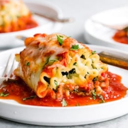 These EASY Spinach Lasagna Roll ups are totally delicious, perfect for entertaining or serving for weeknight meals. Individual vegetarian lasagnas filled with spinach and cheese are family-friendly, satisfying and perfect for portion control. It's also a great way to get your kids to eat spinach and no one will miss the meat!
