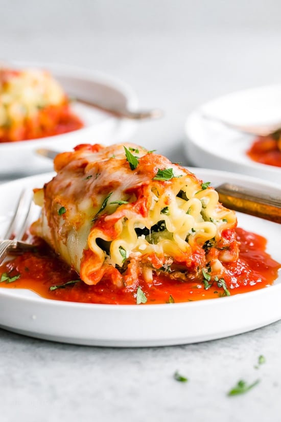 These EASY Spinach Lasagna Roll ups are totally delicious, perfect for entertaining or serving for weeknight meals. Individual vegetarian lasagnas filled with spinach and cheese are family-friendly, satisfying and perfect for portion control. It's also a great way to get your kids to eat spinach and no one will miss the meat!