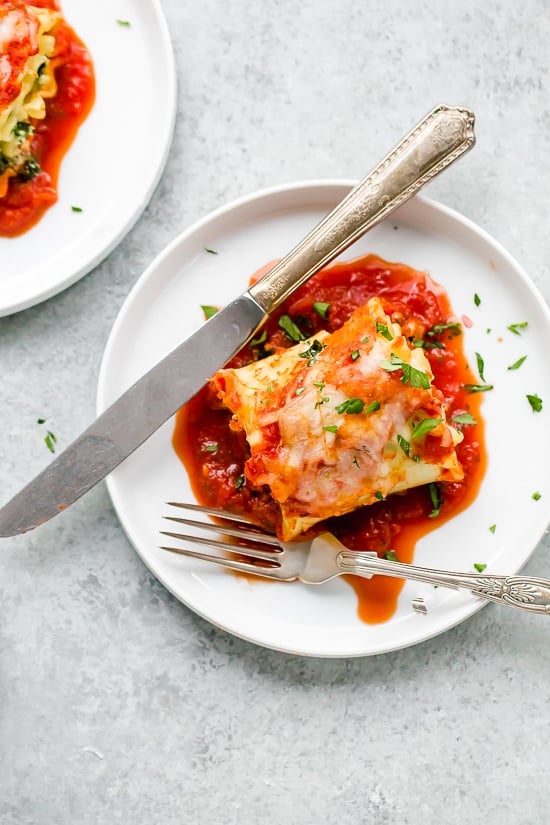 These EASY Spinach Lasagna Roll ups are totally delicious, perfect for entertaining or serving for weeknight meals. Individual vegetarian lasagnas filled with spinach and cheese are family-friendly, satisfying and perfect for portion control. It's also a great way to get your kids to eat spinach and no one will miss the meat!