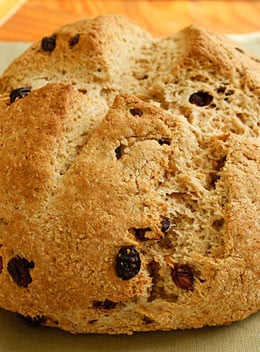 I love to have Irish Soda Bread for breakfast hot out of the oven with some low fat spread and a cup of tea. This is very easy to make, even if you have no experience baking. If you prefer to make a bread to serve with dinner, omit the raisins and sugar and you can add caraway seeds.