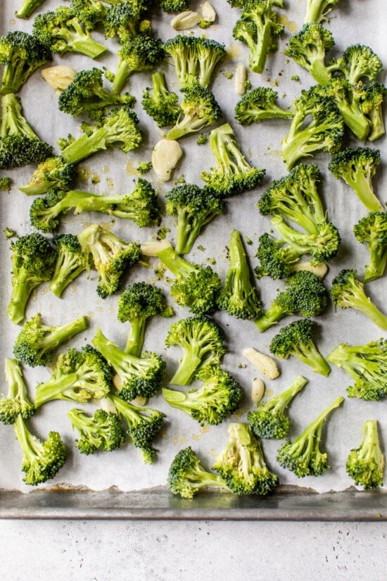 Place broccoli florets, smashed garlic, olive oil, salt and pepper on a sheet pan.