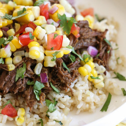 Barbacoa Beef with corn salsa on a plate.