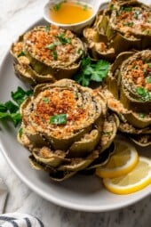 Platter of stuffed artichokes with sliced lemon
