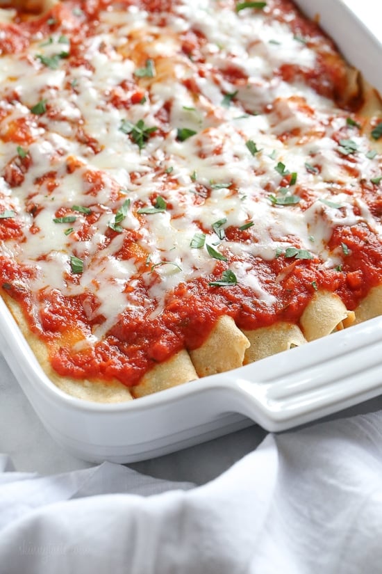 The secret to the best, irresistible manicotti is to make them from scratch with my easy homemade crespelles, which are basically Italian crepes. These spinach and cheese manicotti are filled with three cheeses – ricotta, mozzarella and parmesan, then topped with homemade sauce. So damn delicious!