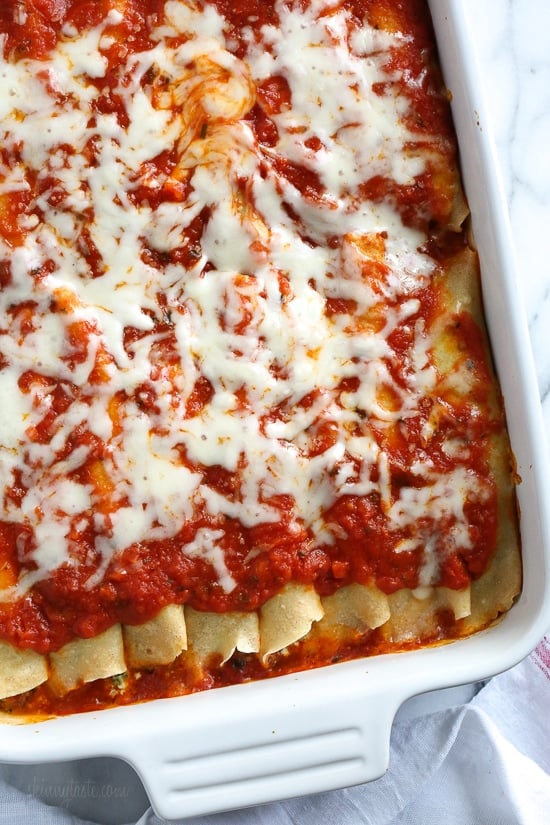 The secret to the best, irresistible manicotti is to make them from scratch with my easy homemade crespelles, which are basically Italian crepes. These spinach and cheese manicotti are filled with three cheeses – ricotta, mozzarella and parmesan, then topped with homemade sauce. So damn delicious!