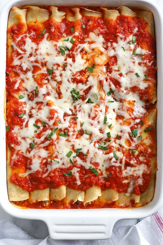 The secret to the best, irresistible manicotti is to make them from scratch with my easy homemade crespelles, which are basically Italian crepes. These spinach and cheese manicotti are filled with three cheeses – ricotta, mozzarella and parmesan, then topped with homemade sauce. So damn delicious!