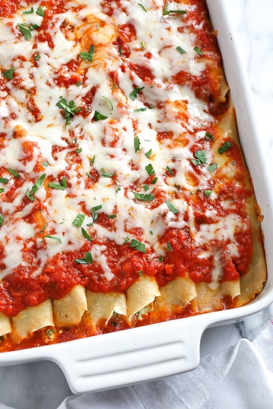 The secret to the best, irresistible manicotti is to make them from scratch with my easy homemade crespelles, which are basically Italian crepes. These spinach and cheese manicotti are filled with three cheeses – ricotta, mozzarella and parmesan, then topped with homemade sauce. So damn delicious!