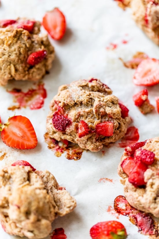 These simple strawberry scones made lighter are a wonderful breakfast and a delicious way to use up fresh summer strawberries! Freshly baked strawberry scones on parchment paper.