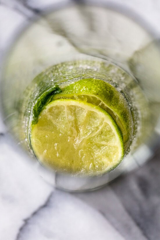 Muddle the limes, mint and sugar.