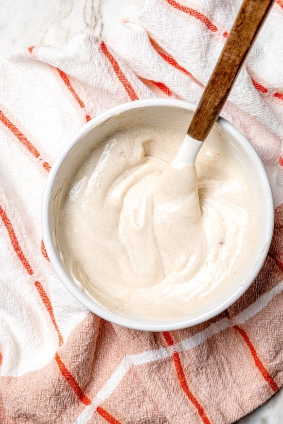 Fruit kabobs are the easiest summer dessert! Made with a rainbow of fruit threaded onto skewers, they’re perfect with a creamy fruit dip. Overhead view of bowl of fruit dip with spoon