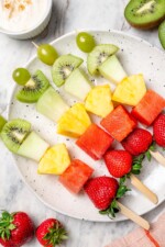 Overhead view of fruit kabobs on platter
